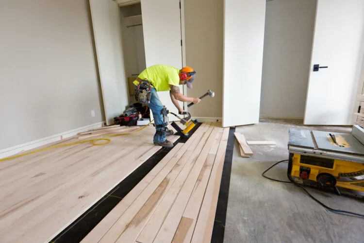 Professional Installing Wooden Floor With Precision Tools