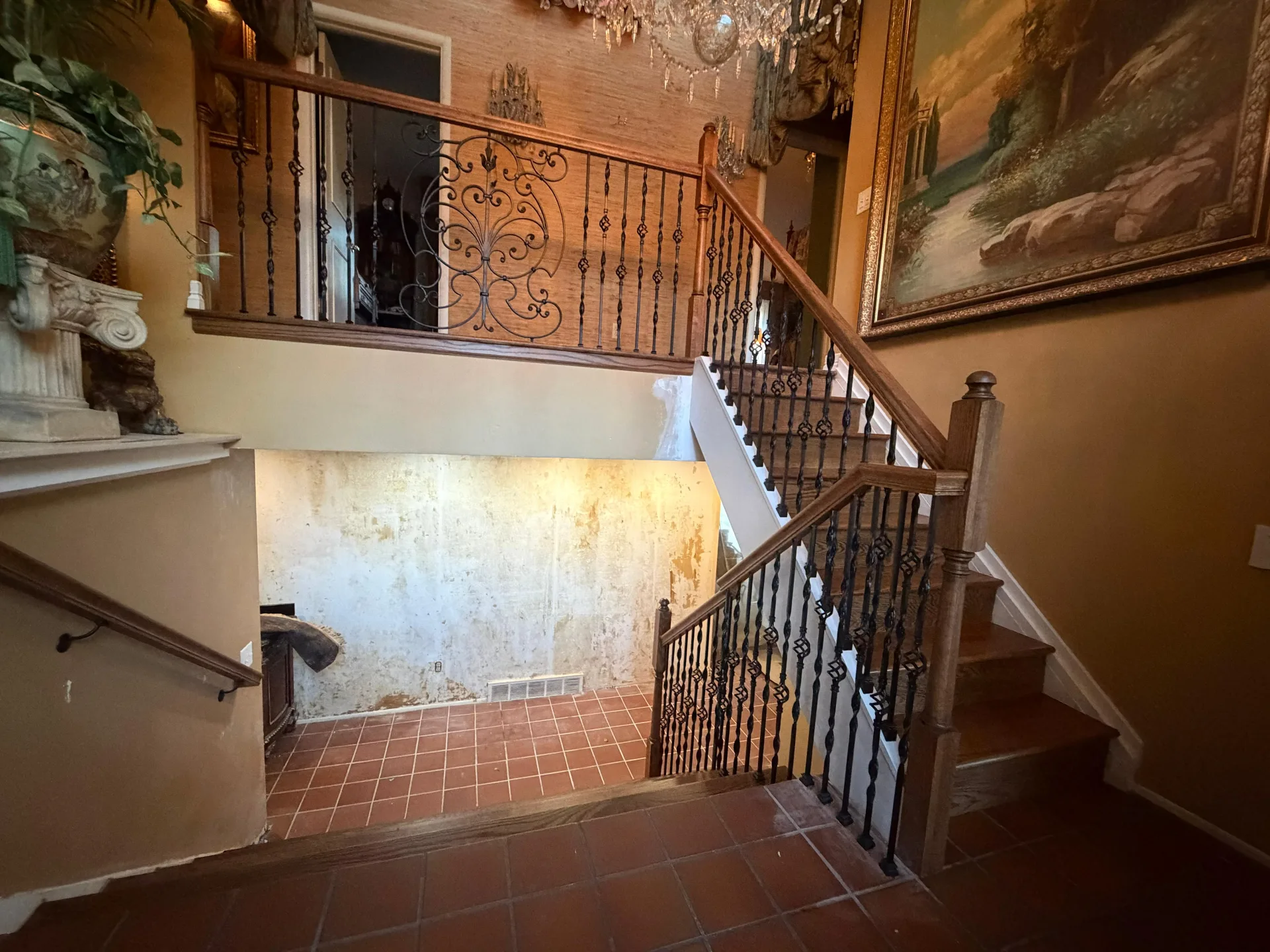 Staircase with an iron railing and wood treads