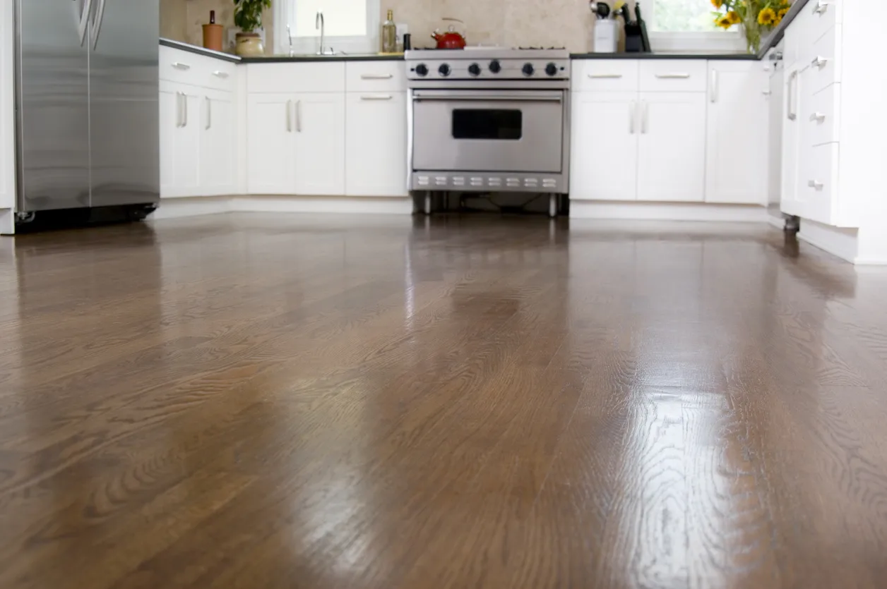 Kitchen interior featuring elegant and freshly refinished hardwood floors