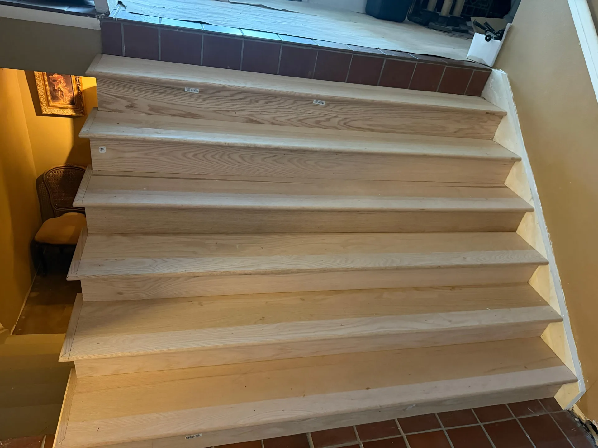 Raw wood stair treads installed and waiting to be finished