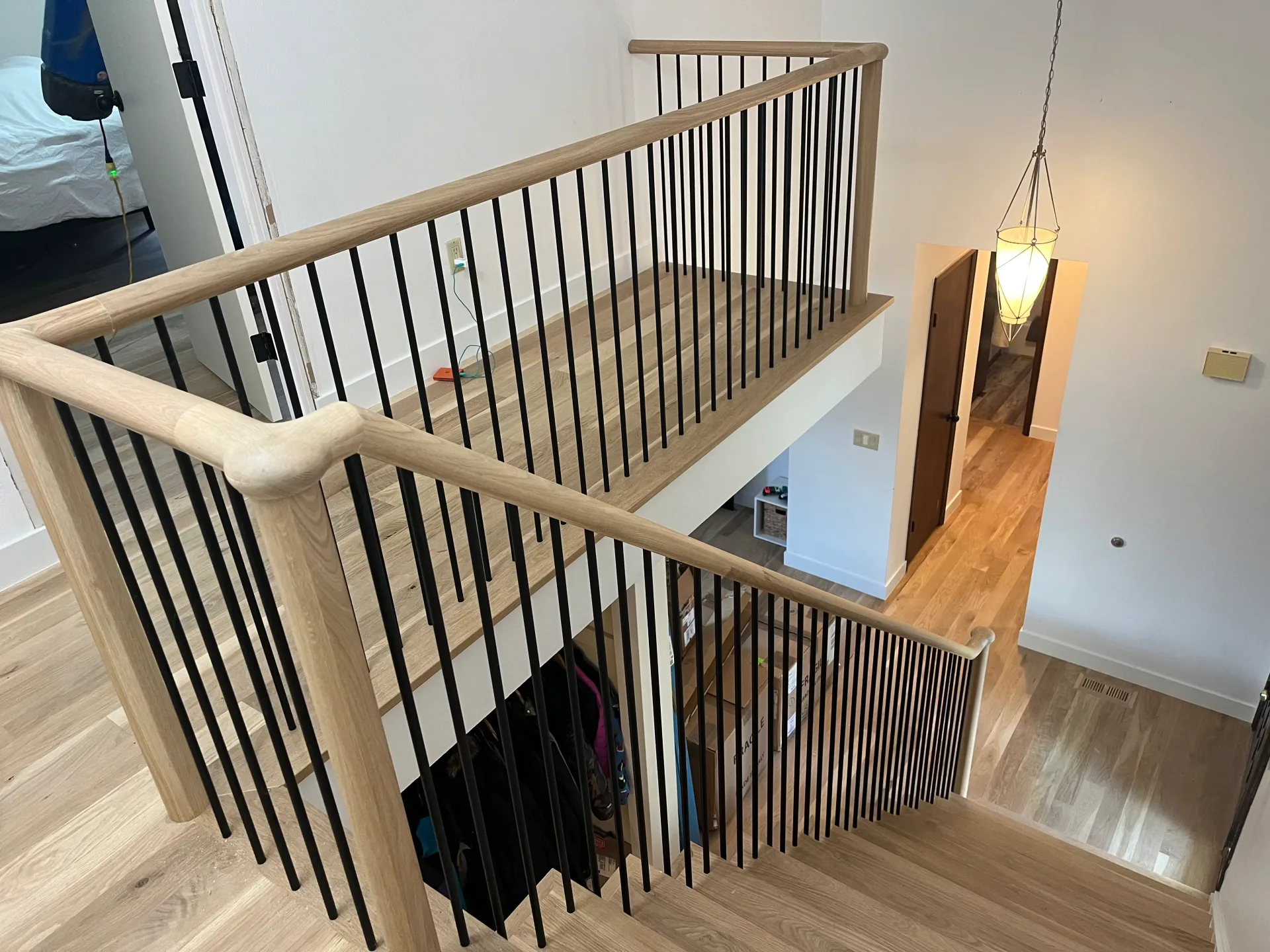 Balcony railing with iron balusters and a wood handrail
