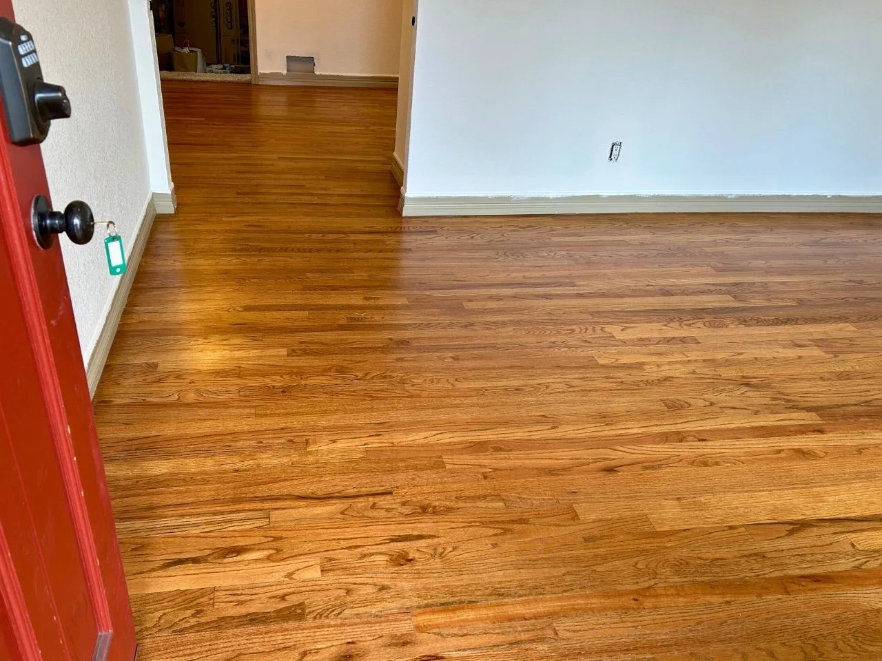 Warm-toned oak floor with a high-gloss finish