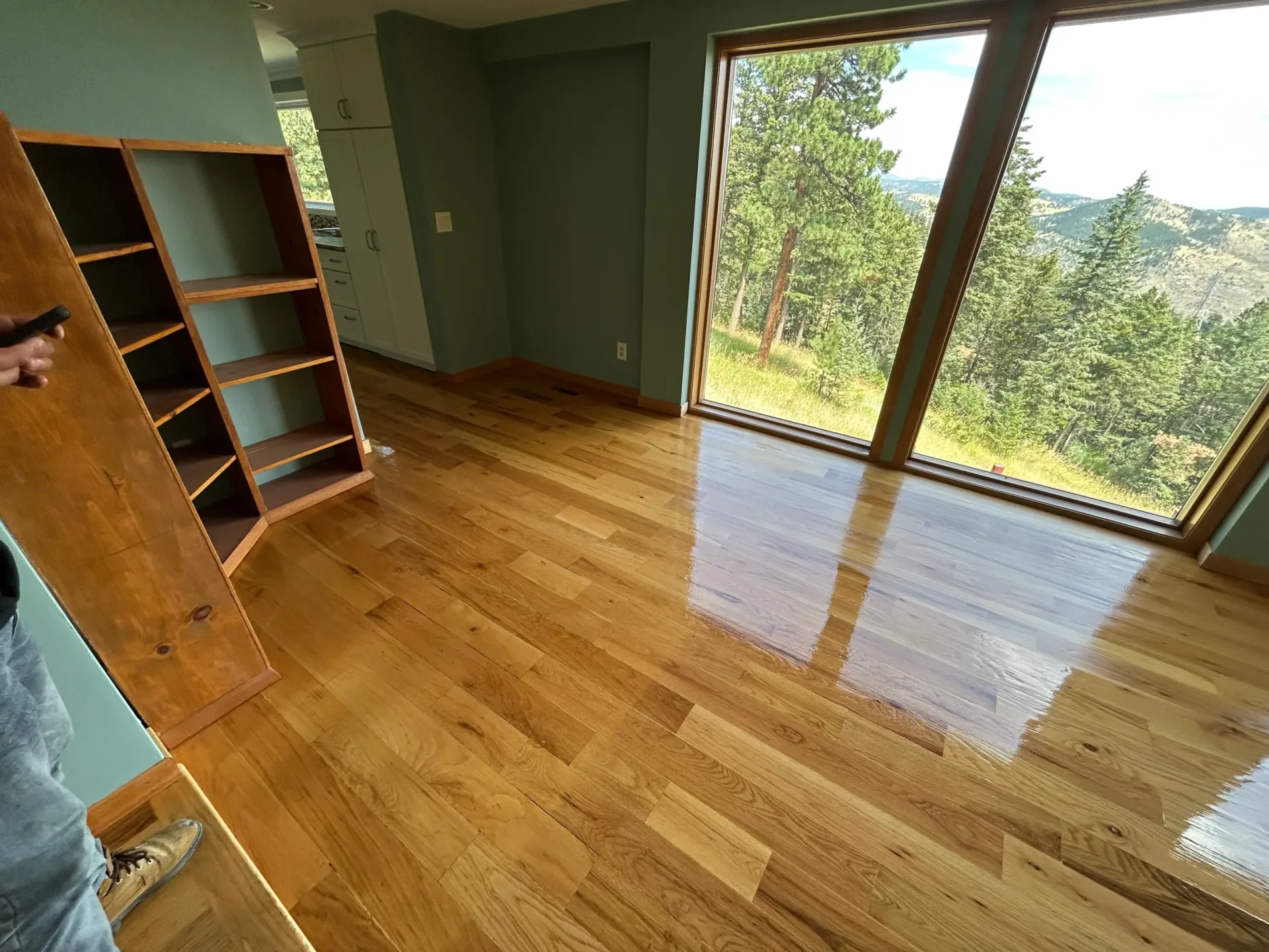 Refinished hardwood floor in a Denver home with floor-to-ceiling windows