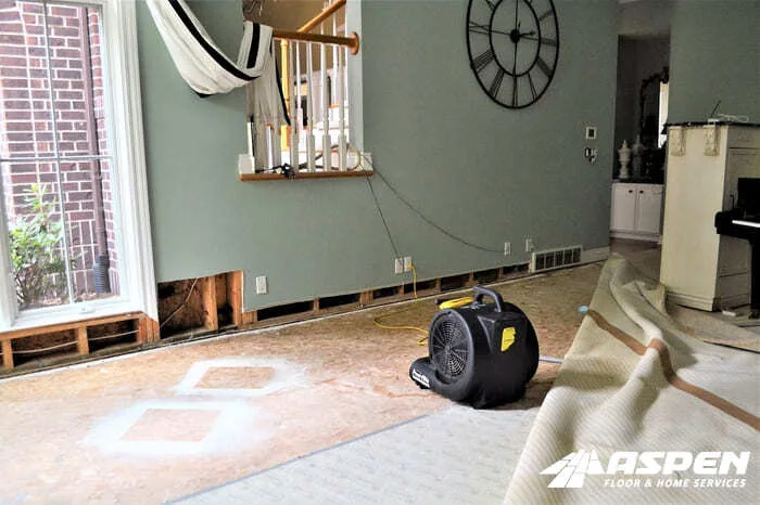 Air mover drying a hardwood floor after water damage