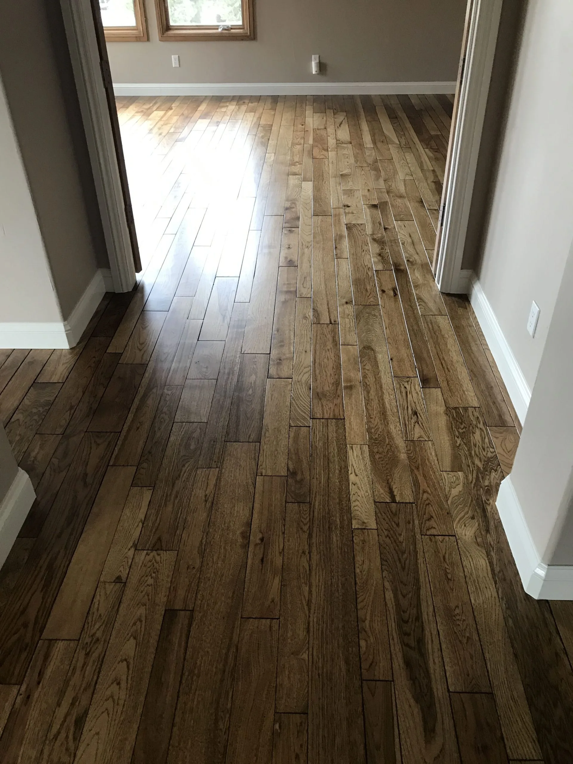 Repaired hardwood floor at a doorway in a Denver home