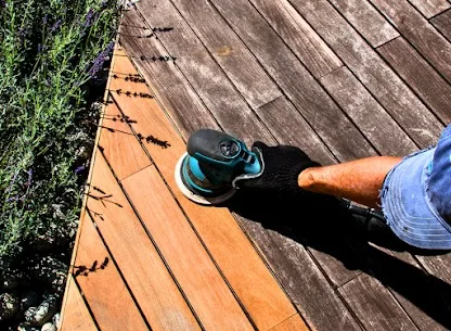 Deck boards being sanded before staining in Denver, Colorado