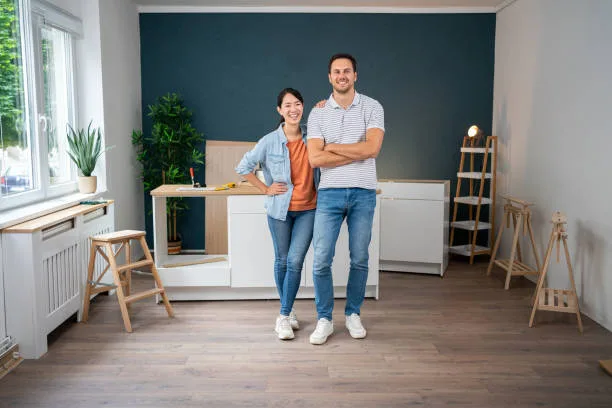 Happy homeowners admiring their beautifully finished hardwood flooring