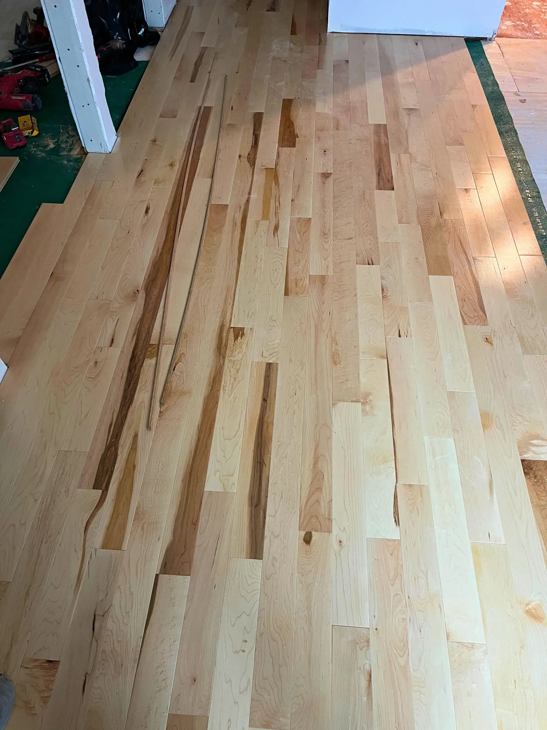 Raw hardwood boards laid out on site before installation