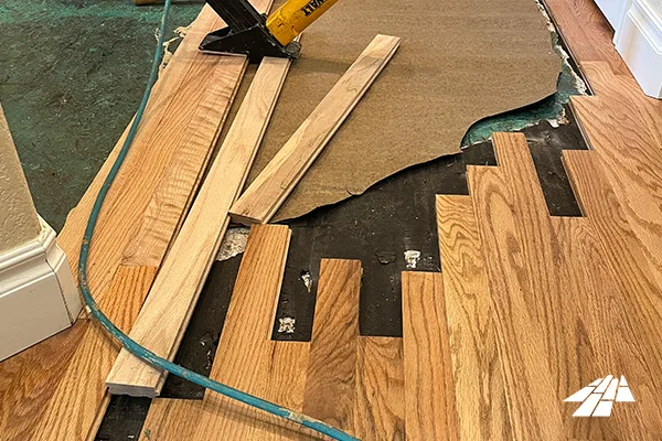 Replacement boards cut and fitted during a hardwood floor repair