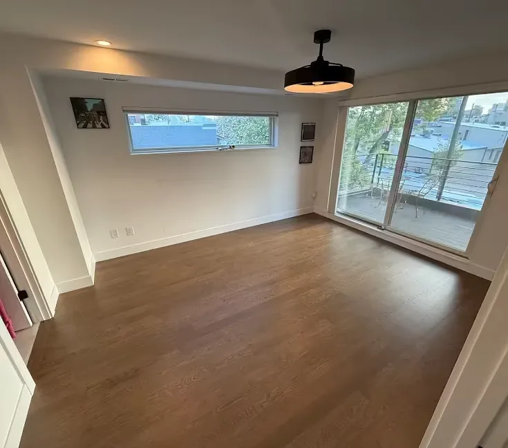 Wood floor in a room opening onto a sliding glass door
