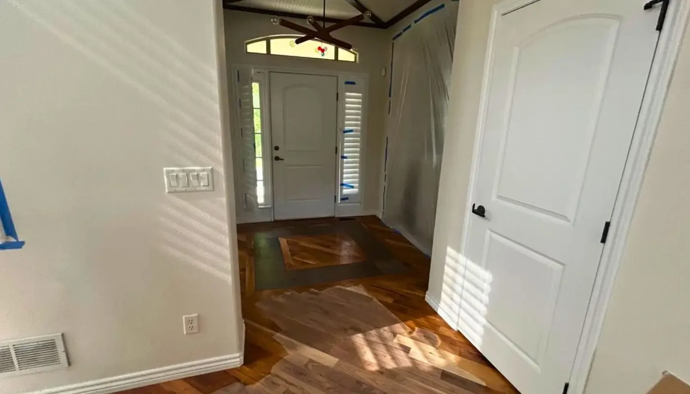 Entryway with hardwood flooring and a glazed front door