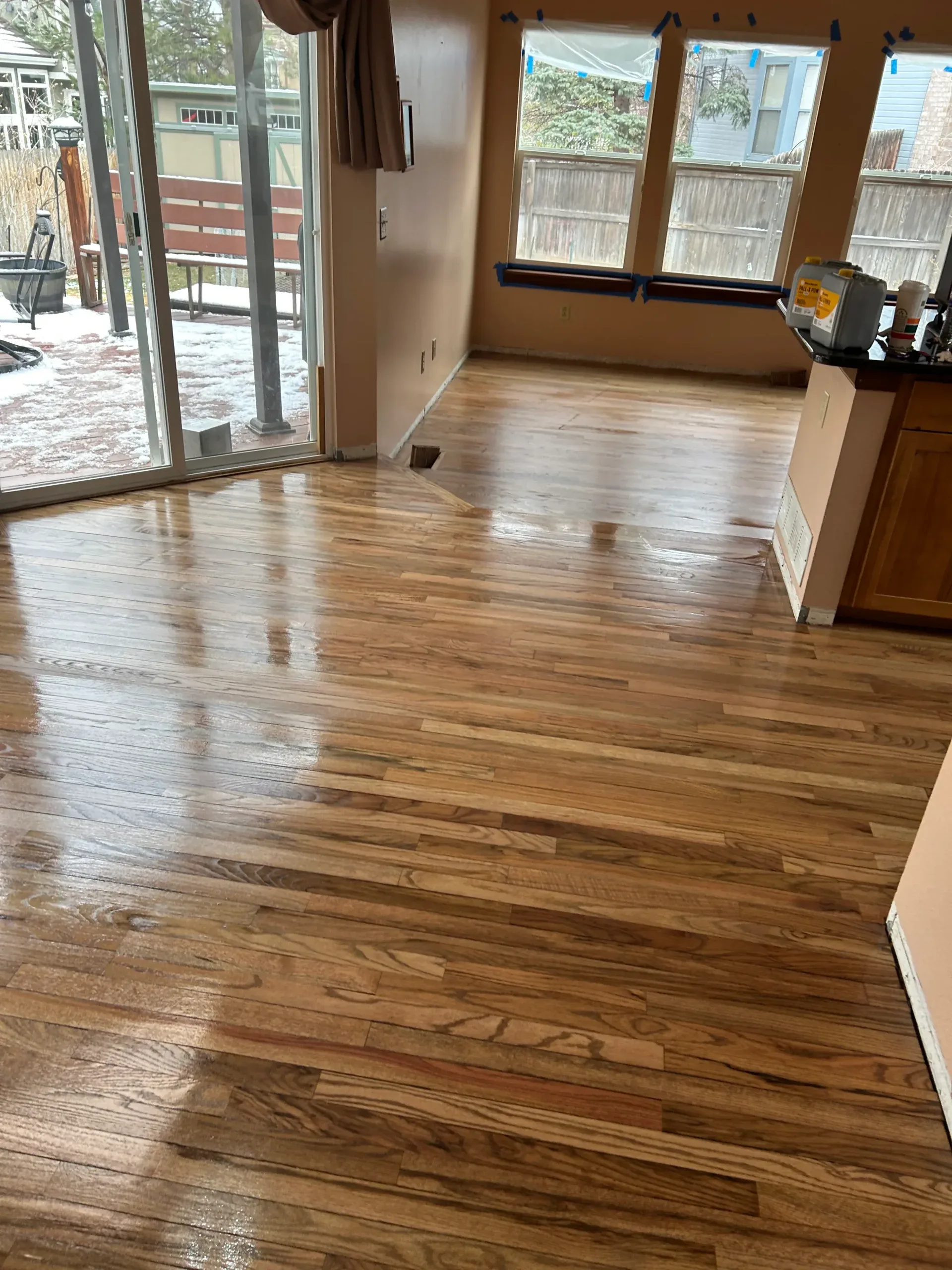 Glossy red oak floor in an open living area after a full sand and refinish