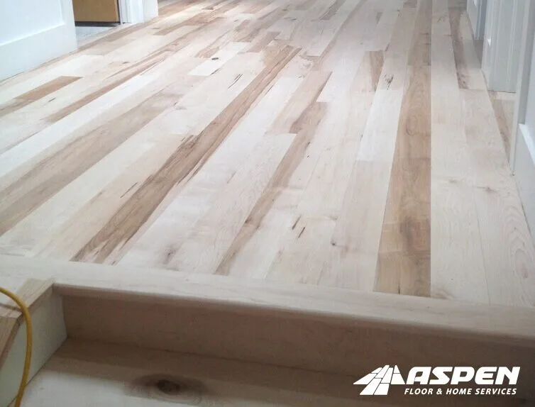 Freshly sanded hardwood floor and step, ready for its finish coats