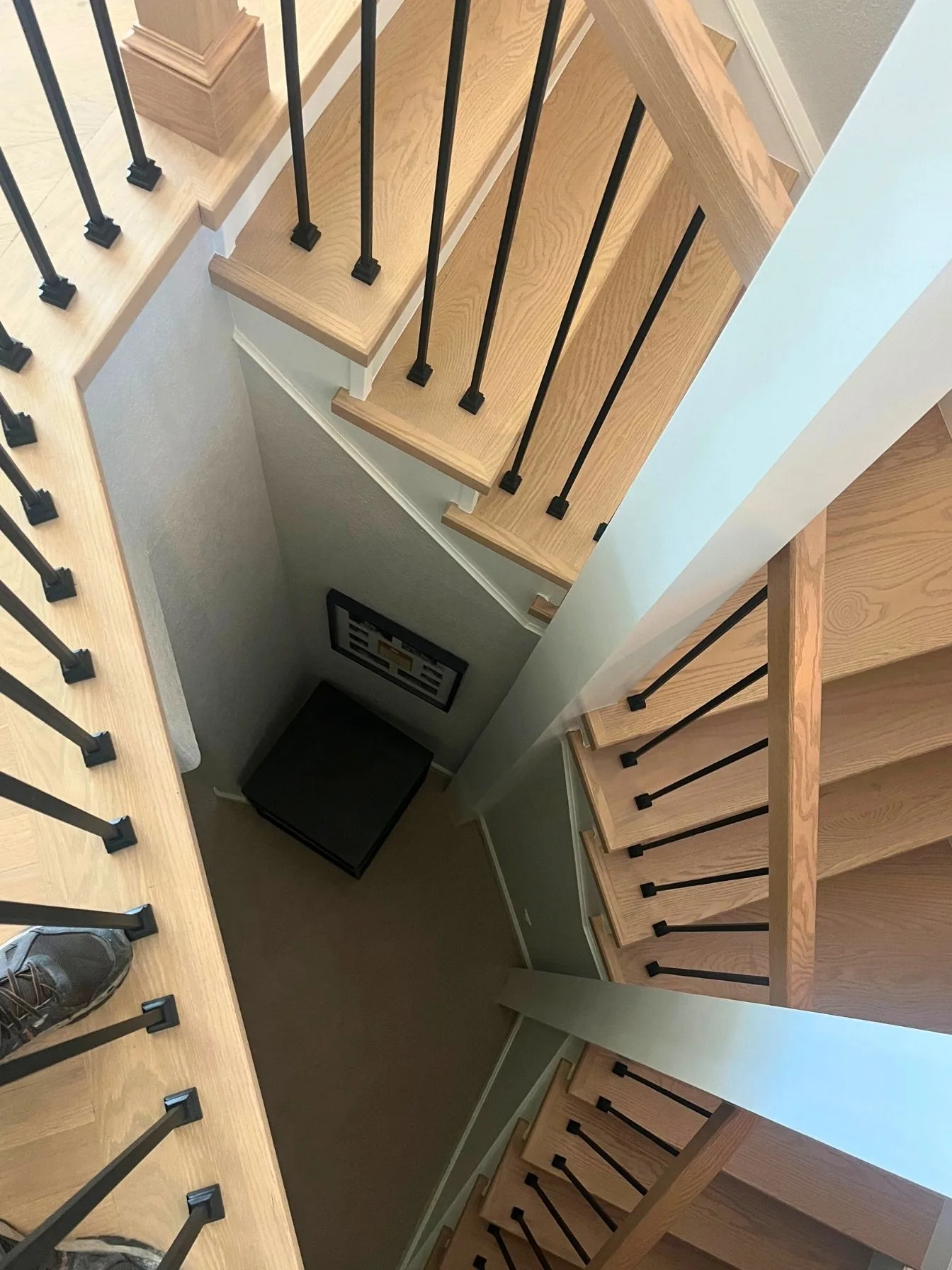 Staircase with iron balusters seen from the upper landing