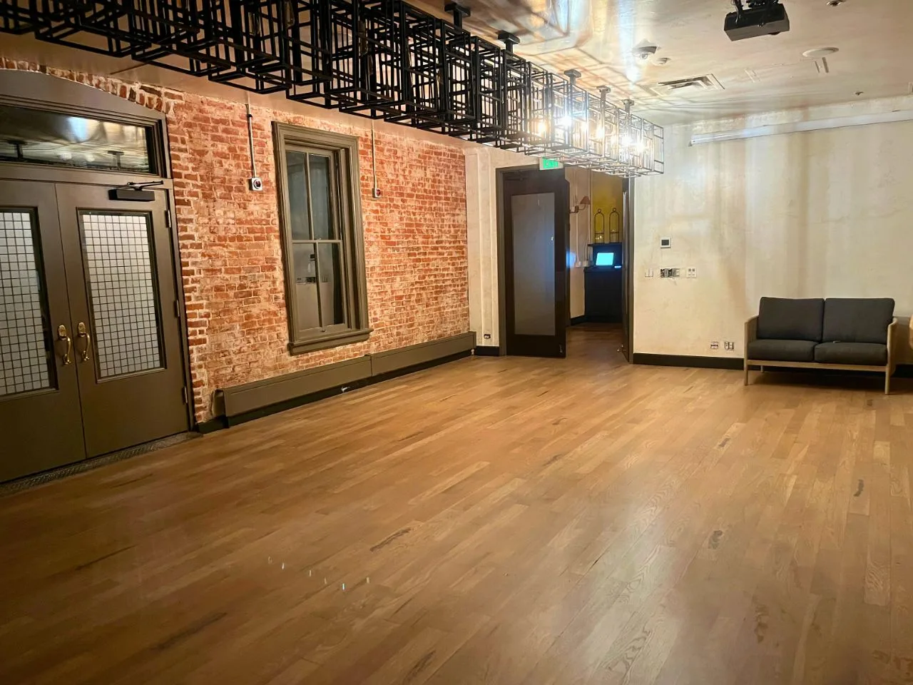 Wide plank wood floor in a brick-walled Denver space