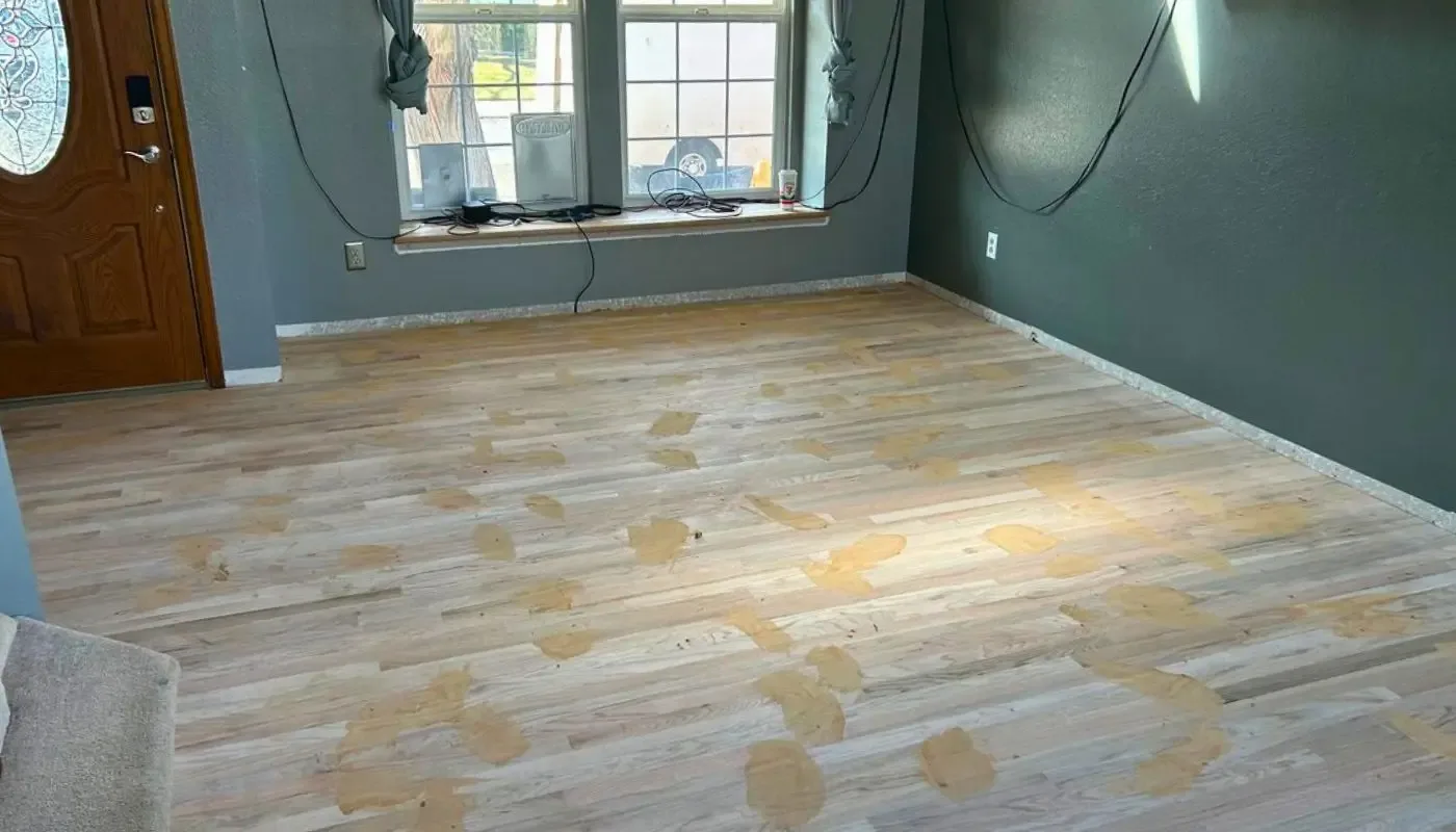Hardwood floor sanded down to bare wood part way through a refinishing project