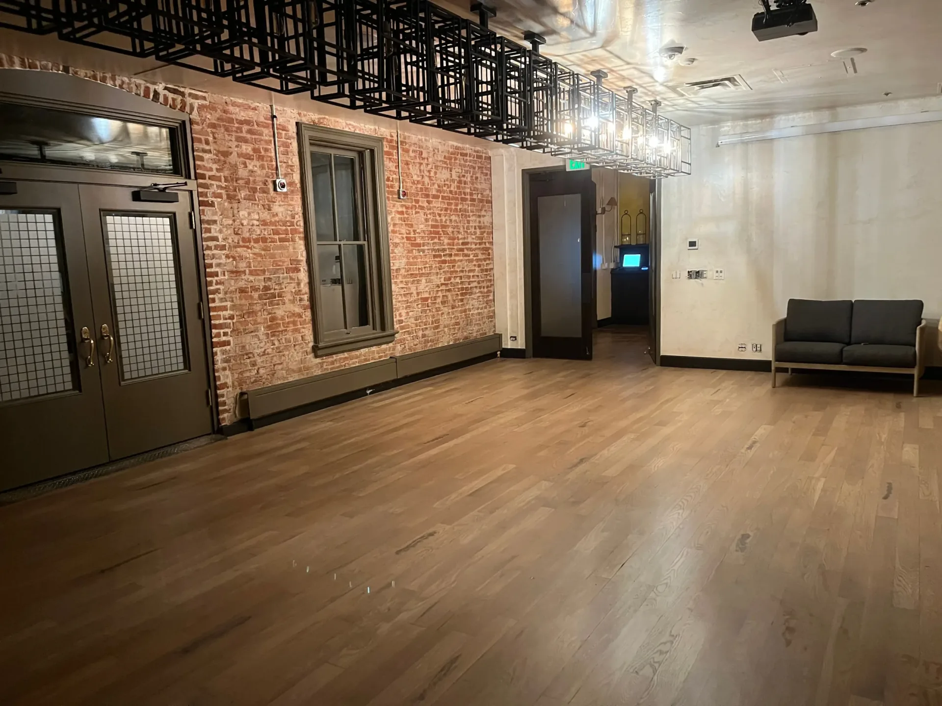 Wide plank hardwood flooring against exposed brick in a Denver restaurant