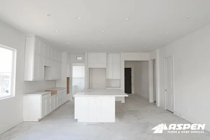 Kitchen mid-remodel with the cabinets in and the floor still bare