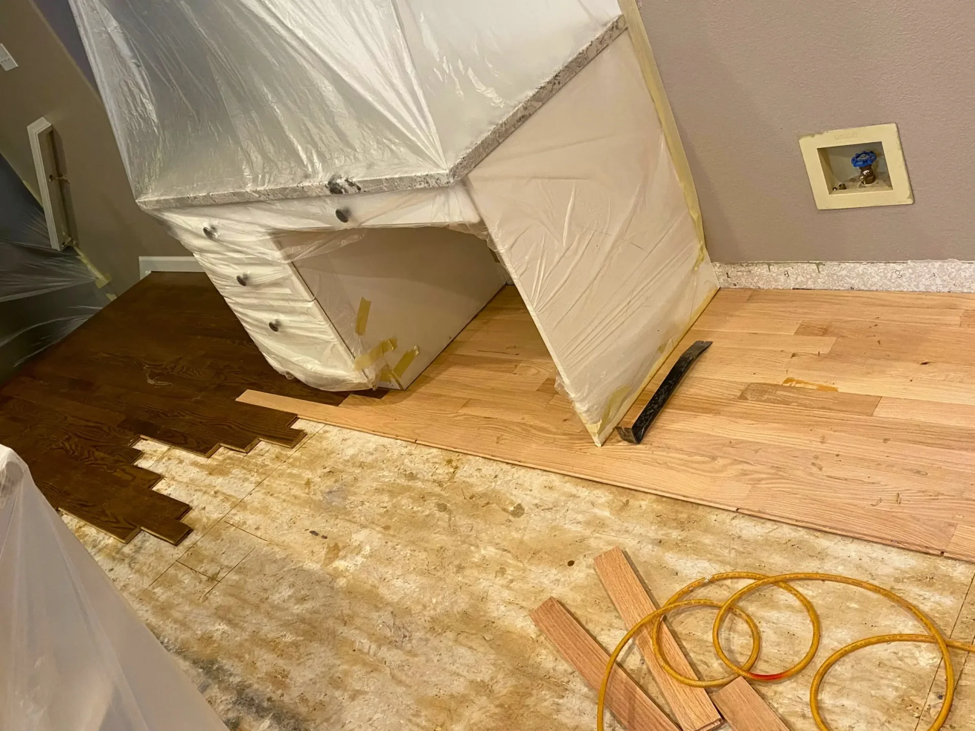 Floor lifted around a desk to expose the subfloor underneath