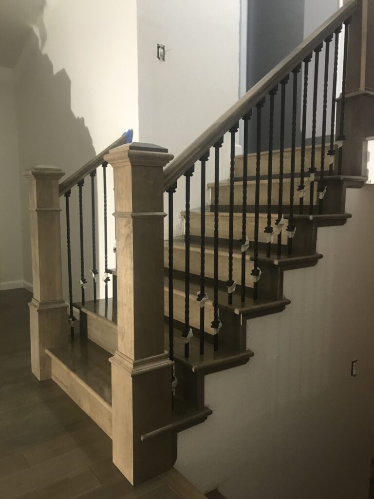 Walnut hardwood stairs installed in Littleton, Colorado, with a rich, dark chocolate stain