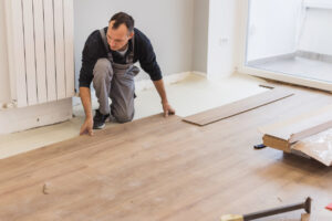 Professional carefully installing new hardwood flooring for a fresh look