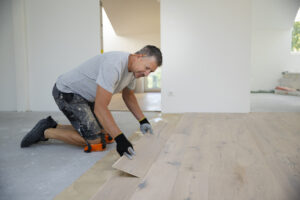 Professional installation of engineered hardwood flooring in a modern home