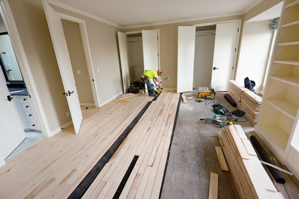 Unfinished hardwood flooring installation in progress for a seamless finish