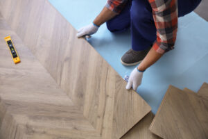 Professional Aligning Hardwood Flooring During Installation