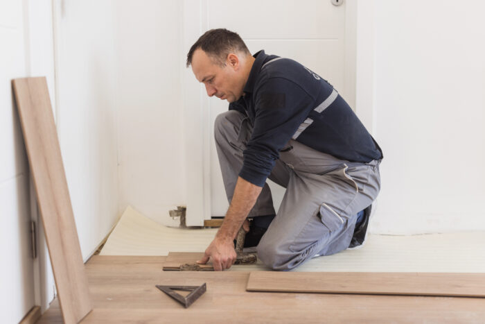 Expert Fitting Hardwood Planks During Precise Flooring Installation