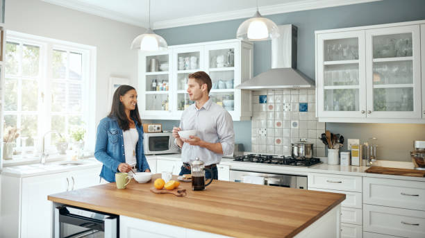 Happy homeowners enjoying the comfort of their newly remodeled kitchen