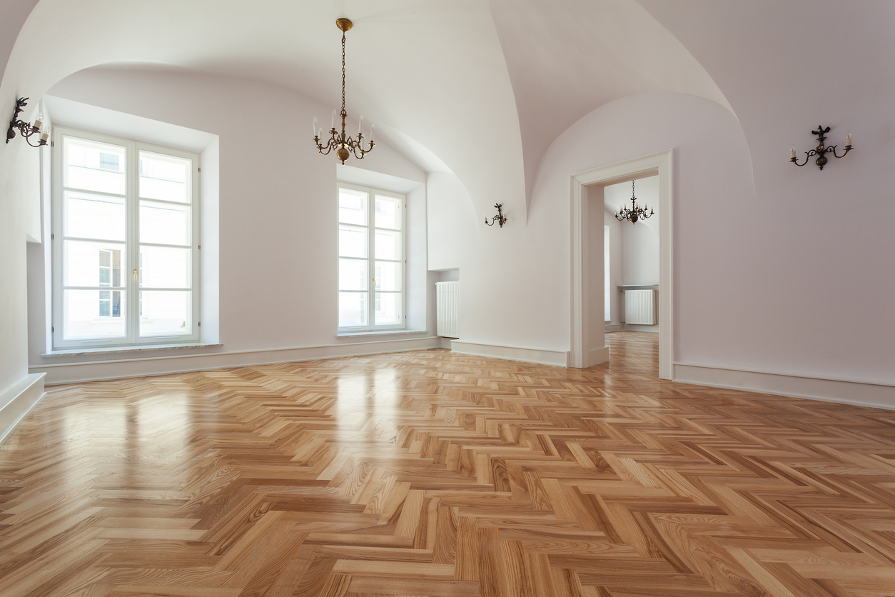 New parquet Hardwood Flooring Installed in Empty Room After Replacement