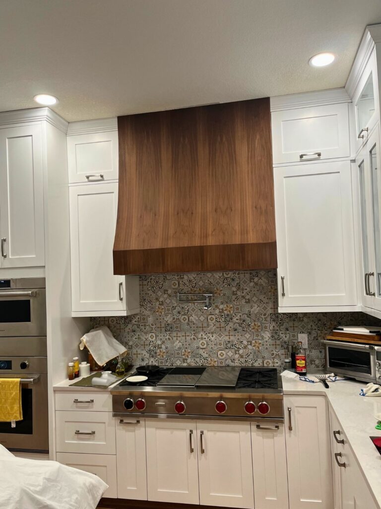 kitchen remodel in Highlands Ranch featuring withe cabinets, granite countertops, and stainless steel appliances