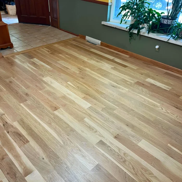 Character-grade mixed tone hardwood flooring installation Denver residential showing natural wood color variation and custom craftsmanship